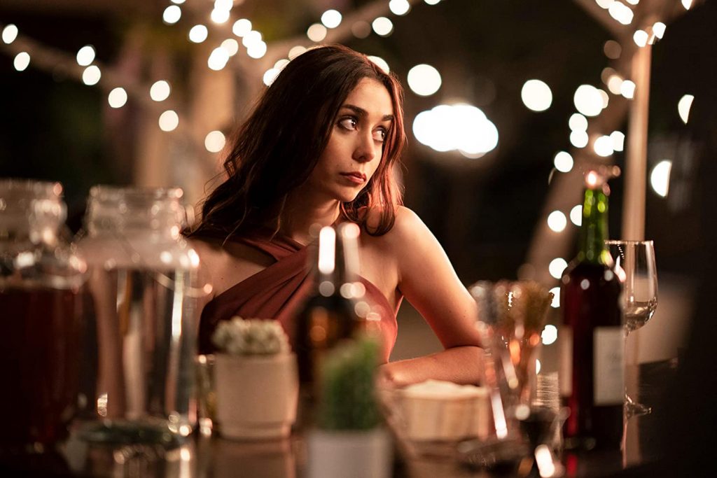 Cristin Milioti siting at a table with various alcohol