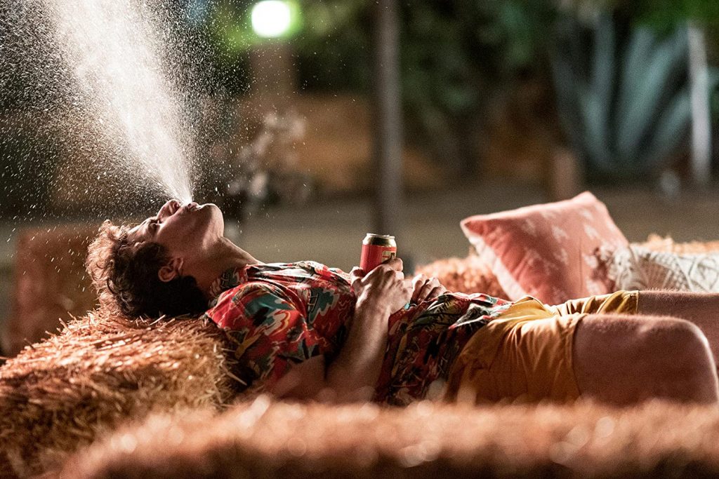 Andy Samberg spitting out a drink