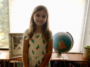 Gigi with the globe and her great-grandmother’s photo