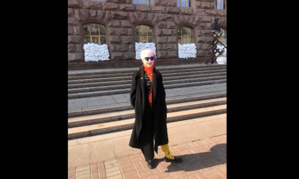 a woman in a black coat stands in Ukraine