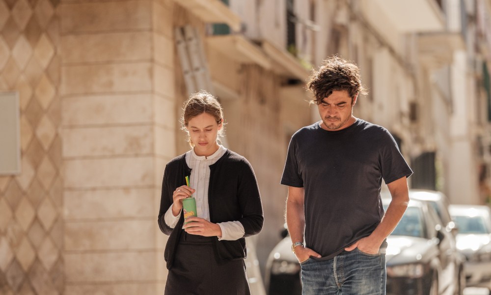 Still of two actors walking down the street