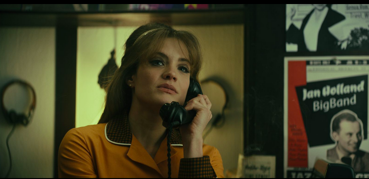 A women giving an ominous look while talking on the phone