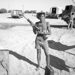man posing with rifle