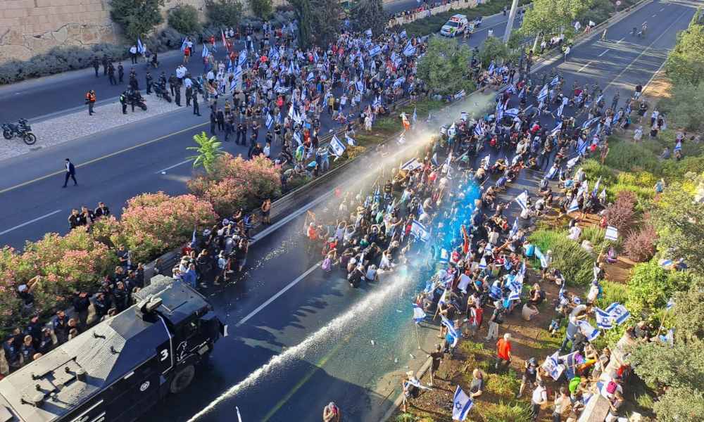 Israeli police spray protesters. Photo credit: Eetta Prince-Gibson