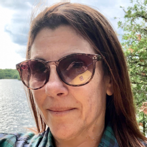 Elaine Aronson taking a selfie overlooking a lake