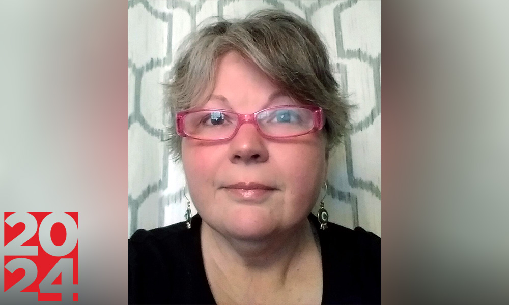 Woman with short hair and pink glasses