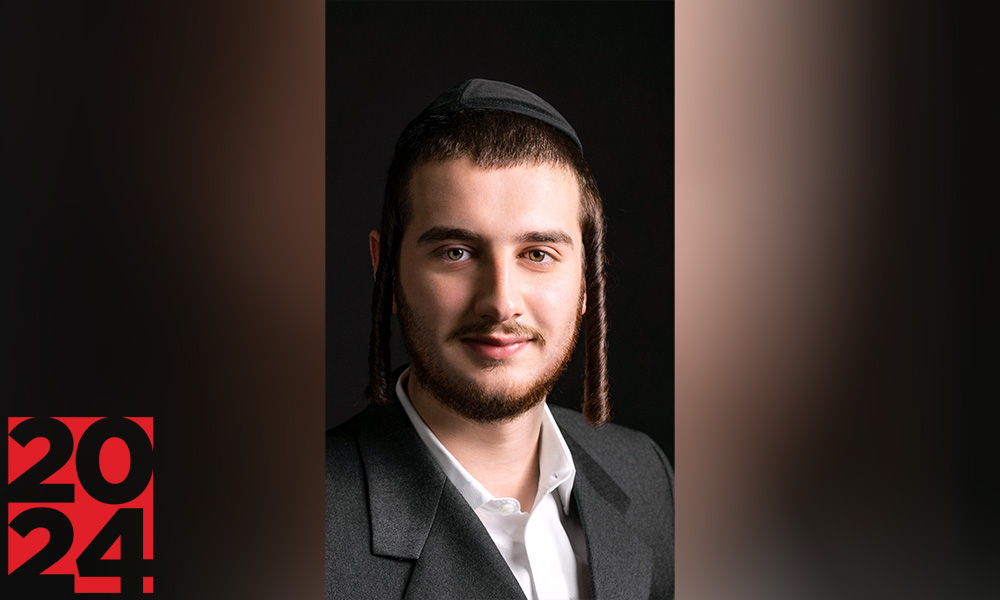 Man with short facial hair, black kippah, and payot.