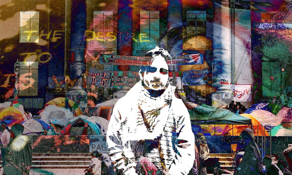 Young man in black and white wearing a keffiyeh stands infront of a building at University of California, Berkeley building. Around him is a colorful collage of tents and banners of an encampment.