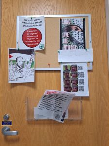 Pro-palestine flyers posted on a door, including one that says "long live the Intifada."
