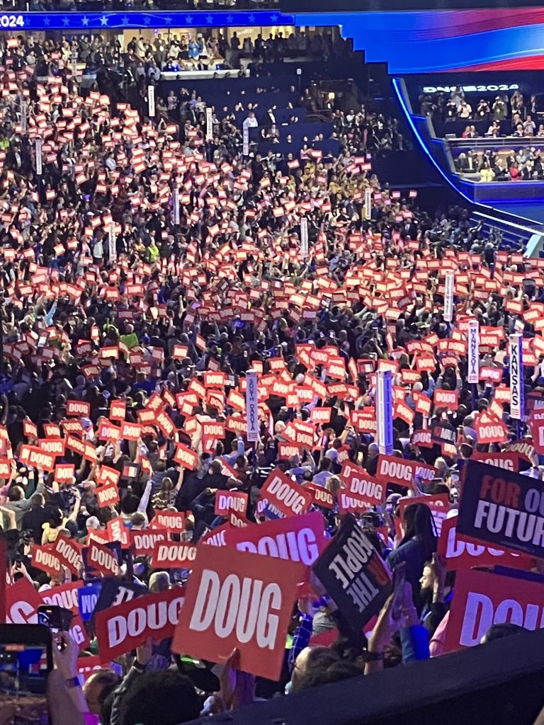 DNC attendees hold "Doug" signs during Doug Emhoff's speech