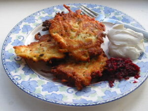 latkes Plate of latkes with sour cream.