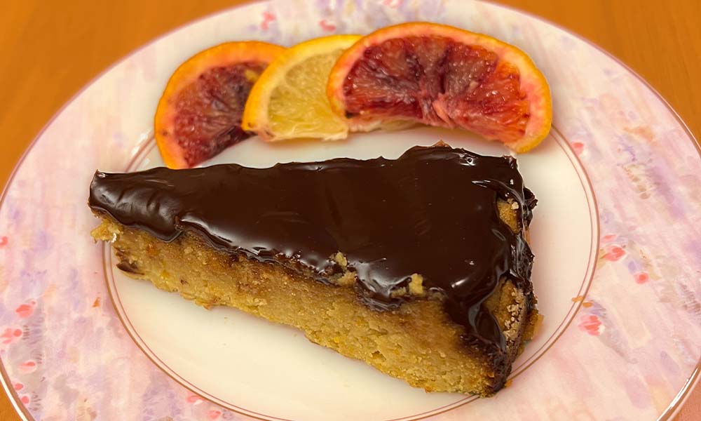 Image of Sephardi orange cake on a plate with blood orange slices.